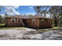 Charming ranch-style home with tan siding, light shutters, and a well-maintained front yard at 15308 Fruitville Rd, Sarasota, FL 34240