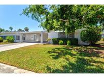 Charming single-story home with a well-manicured lawn and a covered carport for convenient parking at 2435 Terry Ln, Sarasota, FL 34231