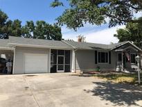 Charming single-story home featuring a screened porch, one car garage, and well-maintained yard with an American flag at 2547 Prospect St, Sarasota, FL 34239