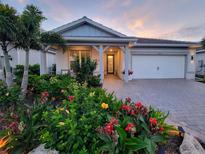 Charming single-story home with a two-car garage, beautifully landscaped front yard and covered entry at 26017 Seastone Dr, Englewood, FL 34223