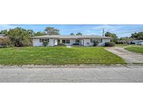 Charming single-story home with a well-maintained lawn and classic curb appeal at 2702 Bedford Way, Sarasota, FL 34239