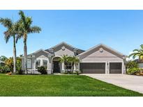 Beautiful single-story home with a manicured lawn and mature palm trees at 3015 160Th E Ter, Parrish, FL 34219
