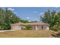 Charming single-story home with a well-maintained lawn and attached two-car garage at 3204 Pericles Ave, North Port, FL 34286