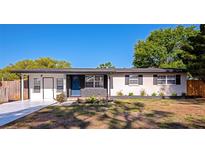 Charming single-story home with a blue front door, black accents, and newly landscaped front yard at 4812 21St W St, Bradenton, FL 34207