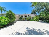 Beautiful home with a sprawling driveway, two-car garage, and lush tropical foliage at 6102 Sonesta Ct, Bradenton, FL 34202