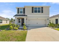 Charming two-story home with a well-maintained lawn and a spacious two-car garage at 6314 Distant Haze Pl, Palmetto, FL 34221