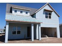 Charming two-story home with a light blue exterior and attached garage at 658 Maldives Trl, Sarasota, FL 34234