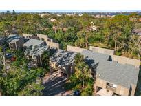 An aerial view of townhomes surrounded by lush landscaping, offering a serene and private living environment at 754 Pine Run Dr # 754, Osprey, FL 34229