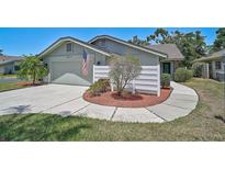 Charming home featuring a well-manicured front yard, a garage, and a decorative fence, creating an inviting curb appeal at 7817 Pine Trace Dr # 15, Sarasota, FL 34243