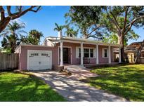 Charming single-story home with a welcoming front porch and well-manicured lawn at 1830 Virginia Dr, Bradenton, FL 34205