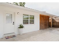 Charming home exterior with white walls, stylish lattice and a welcoming front entrance at 2300 Stratford Dr, Sarasota, FL 34232