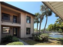 Inviting two-story condo featuring a well-maintained lawn and a serene pond with a fountain at 2808 60Th W Ave # 1924, Bradenton, FL 34207