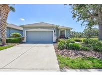 Charming one-story home featuring a two-car garage, well-maintained landscaping, and inviting curb appeal at 4740 105Th E Ave, Parrish, FL 34219