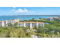 Stunning aerial shot of a waterfront condo complex with lush landscaping and beautiful blue waters at 4801 Osprey S Dr # 405, St Petersburg, FL 33711