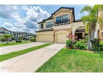 Charming two-story townhome with a well-manicured lawn and a two-car garage at 5155 78Th St E Cir, Bradenton, FL 34203
