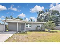Charming single-story home featuring a carport, a well-maintained lawn, and freshly painted exterior at 5905 Olive Ave, Sarasota, FL 34231