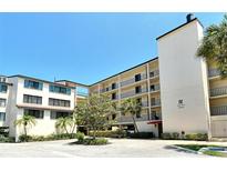 Ischia Condominium building with multiple floors and balconies on a sunny day at 6285 Midnight Pass Rd # 403, Sarasota, FL 34242