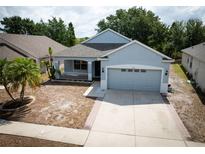 Charming single-Gathering home with a well-maintained lawn and attached two-car garage at 6711 Cambridge Park Dr, Apollo Beach, FL 33572