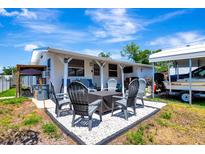 Outdoor patio area with table, chairs and grill for outdoor dining and relaxation, perfect for entertaining guests at 997 28Th Avenue E Dr, Bradenton, FL 34208