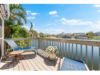 Waterfront deck with lounge chairs and views of the surrounding community at 1211 Spoonbill Landings Cir, Bradenton, FL 34209