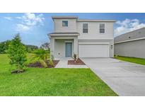 Charming two-story home with manicured lawn and a two-car garage, creating a welcoming curb appeal at 13132 Bayberry Way, Parrish, FL 34219