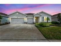 Beautiful one-story home featuring a three-car garage and a well-manicured lawn at 17032 Harvest Moon Way, Bradenton, FL 34211