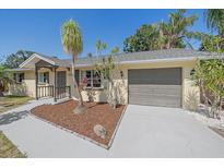 Charming single-story home with a well-manicured lawn and a neutral color palette at 2226 Fairfield Ave, Sarasota, FL 34232