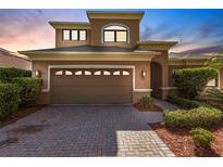 Inviting two-story home with a spacious two-car garage and attractive brick driveway at 235 Dahlia Ct, Bradenton, FL 34212