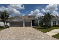 Charming single-story home with a paved driveway and a two-car garage at 25240 Keygrass Ct, Punta Gorda, FL 33955