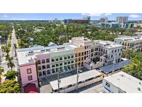 Stunning aerial view of multi-story building showcasing colorful architecture and a vibrant urban landscape at 555 N Orange Ave # 307, Sarasota, FL 34236