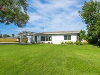 Charming single-story home featuring a well-manicured lawn and welcoming entrance in a residential neighborhood at 6116 Rodgers Ave, Sarasota, FL 34231