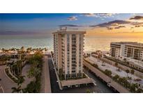 Stunning beachfront high-rise condo with private parking, manicured landscaping, and beautiful ocean views at sunset at 1212 Benjamin Franklin Dr # 909, Sarasota, FL 34236