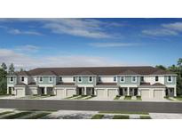 New townhomes featuring attached garages, lush landscaping, and modern architectural details at 15148 Cuzcorro Ct, Nokomis, FL 34275