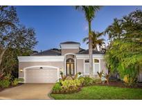 Charming single-Gathering home featuring lush landscaping, brick driveway and a neutral color palette at 3521 Fair Oaks Ln, Longboat Key, FL 34228