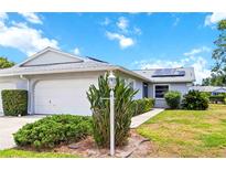 Charming single-story home with well-maintained landscaping and solar panels for energy efficiency at 3662 Bonaventure Ct, Sarasota, FL 34243
