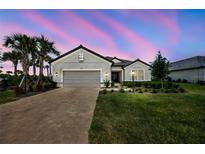 Beautiful one-story home featuring a well-manicured lawn, brick driveway, and a two-car garage at 3679 Santa Caterina Blvd, Bradenton, FL 34211
