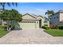 Charming single-Gathering home showcasing a lush lawn and welcoming two-car garage at 3740 Summerwind Cir, Bradenton, FL 34209