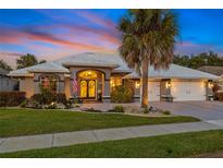 Charming single-Gathering home with a well-manicured lawn, double door entry, and three-car garage at 490 Pine Lily Way, Venice, FL 34293