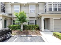Inviting townhome exterior with a well-manicured lawn and private parking at 7593 Plantation Cir, Bradenton, FL 34201