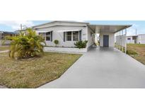 Charming single-story home with a covered carport, landscaped yard, and a welcoming facade at 1005 45Th E Ave, Ellenton, FL 34222