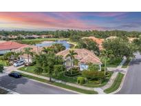 Stunning single Gathering home featuring mature landscaping and a beautiful barrel tile roof at 1311 Tuscany Blvd, Venice, FL 34292
