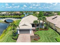 Stunning waterfront home featuring a tile roof, well-manicured lawn and mature palm trees at 13167 Fernando St, Venice, FL 34293