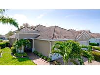Tile roof and well-maintained landscaping add beauty to the exterior of this lovely tan stucco home at 1503 Calle Grand St, Bradenton, FL 34209