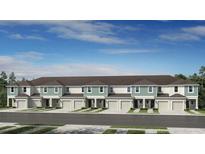 Charming townhome showcases an attractive facade and well-manicured landscaping, set against a serene blue sky at 15188 Cuzcorro Ct, Nokomis, FL 34275