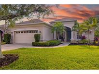 Charming single-story home boasts a lush lawn, mature landscaping, and a welcoming front porch area at 224 Dahlia Ct, Bradenton, FL 34212