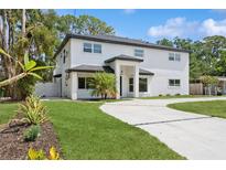 Stunning two-story home boasts a modern design, lush landscaping, and a welcoming circular driveway at 2655 Bay St, Sarasota, FL 34237