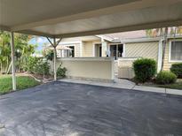 Residential property featuring a covered carport and walkway leading to the entrance at 3002 Sail Pointe Cir # 1B, Venice, FL 34293