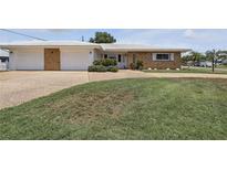 Charming single-story home featuring a stone facade and well-maintained landscaping at 3105 Gulfgate Dr, Sarasota, FL 34231