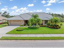 Charming home with lush landscaping, circular driveway and beautiful tile roof at 4625 Deer Creek Blvd, Sarasota, FL 34238