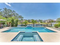 Sparkling pool and spa overlooking the serene lake at 5717 71St E St, Palmetto, FL 34221